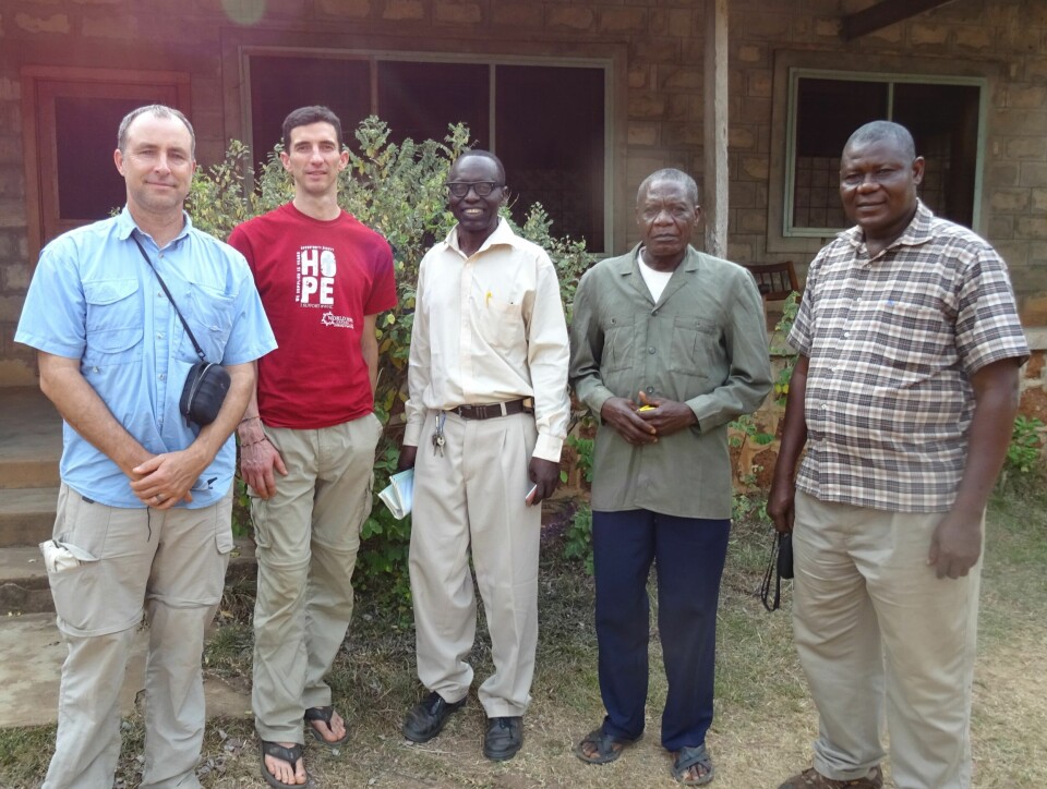 Randy Bevis, Peter Corey and Pastor Dole Emmanuel alongside some local fish farmers
