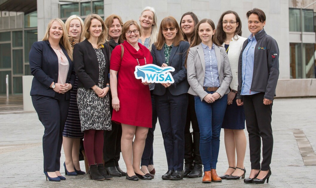 SAIC chief Heather Jones, left, and Rowena Hoare, senior researcher at the IoA, hold the WiSA logo as women working in Scottish aquaculture celebrate the launch of the organisation outside the Scottish Parliament. Photo: WiSA. SAIC chief Heather Jones, left, and Rowena Hoare, senior researcher at the IoA, hold the WiSA logo as women working in Scottish aquaculture celebrate the launch of the organisation outside the Scottish Parliament. Photo: WiSA.