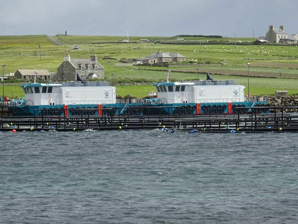 Cooke's new feed barges at Uyeasound pier, Unst. Photo: Cooke Aquaculture Scotland.