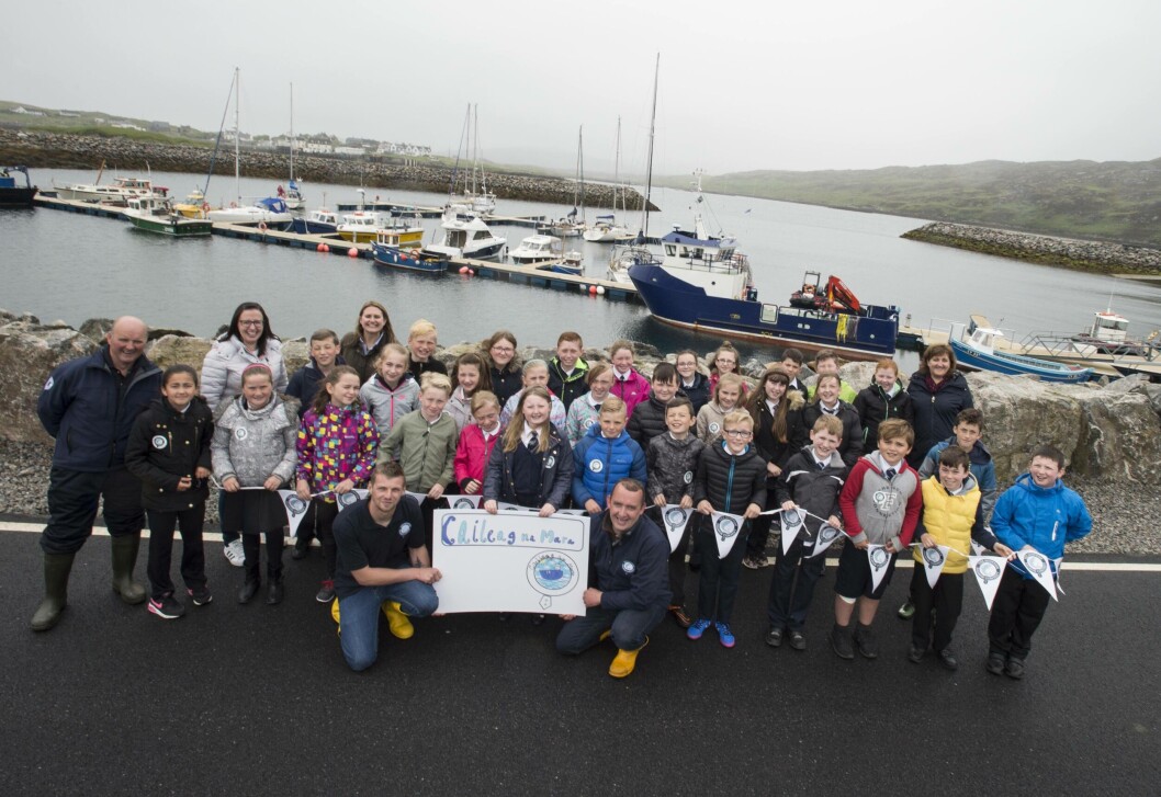 Sine Macleod from Snishival on South Uist with her schoolmates and SSC employees in front of the Caileag na Mara. Photo: Christian Cooksey/SSC. Sine Macleod from Snishival on South Uist with her schoolmates and SSC employees in front of the Caileag na Mara. Photo: Christian Cooksey/SSC.