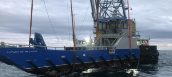 Sunken workboat lifted on to salvage ship