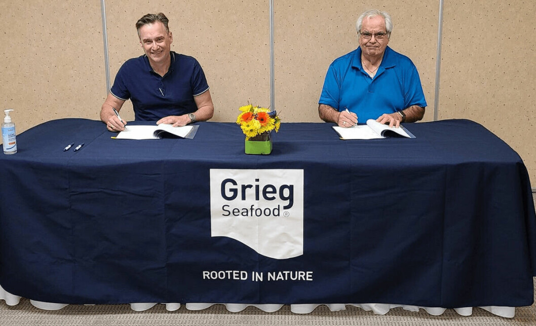 Grieg Seafood BC managing director, Rocky Boschman, left, and Councillor Thomas Smith sign the contract. Photo: Grieg Seafood.