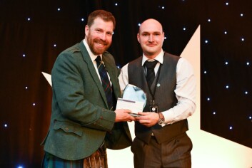 Janis Brivkalns receives his first award from host Jim Smith. Click on photo to enlarge. Photo: Lantra Scotland.