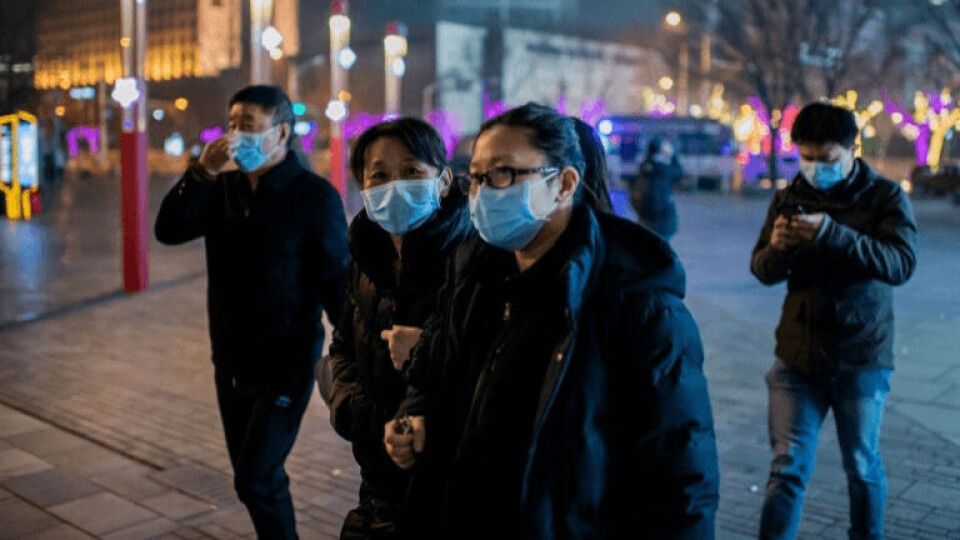 People walking through the Sanlitun area of Beijing, wearing masks to protect against coronavirus. Photo: AFP Agency.