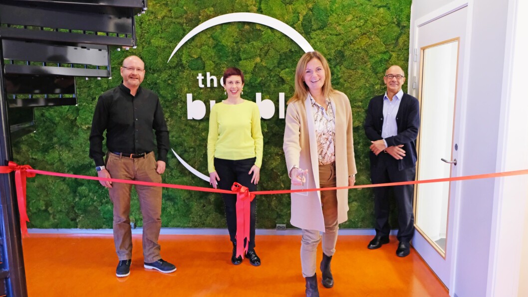 Skretting chief executive Therese Log Bergjord cuts a ribbon to open The Bubble, watched by, from left: Charles McGurk, fish and shrimp health R&D manager; team leader Delphine Crappe; and R&D director Alex Obach. Photo: Skretting.