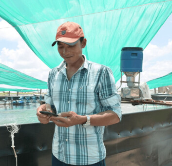 A Vietnamese shrimp farmer uses the XpertSea app. Photo: XpertSea. A Vietnamese shrimp farmer uses the XpertSea app. Photo: XpertSea.