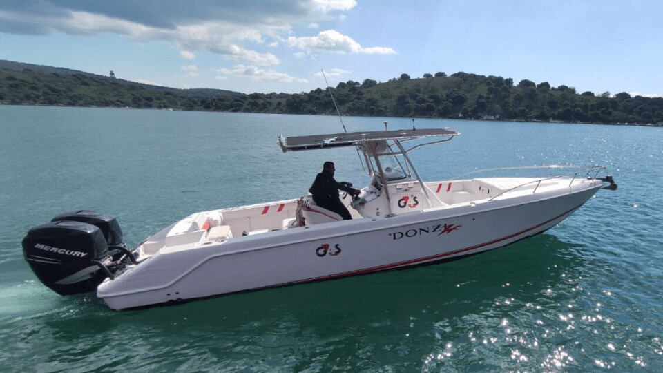 A G4S security guard in a speedboat used for guarding Avramar fish farms. Photo: G4S.