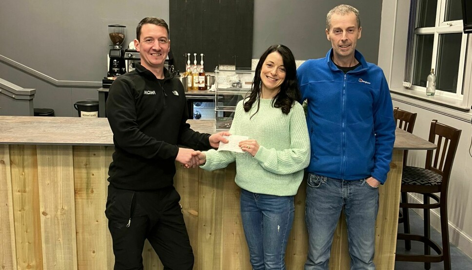 Loch Erisort farm manager David Macmillan, left, presents a donation for the Creagan Cafe to operator Angela Macdonald and Iain Macdonald, treasurer of the North Lochs Community Association (NLCA). The recently-opened cafe, situated in the community hall, doubles as a warm place for anyone struggling with heating and feeding themselves over the winter, and was nominated by Mowi area manager Don MacLeod, who was unable to attend the presentation.