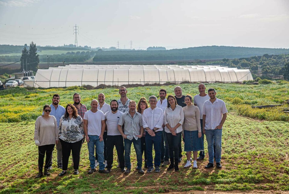 The SimpliiGood team in front of the polytunnels housing their spirulina ponds.