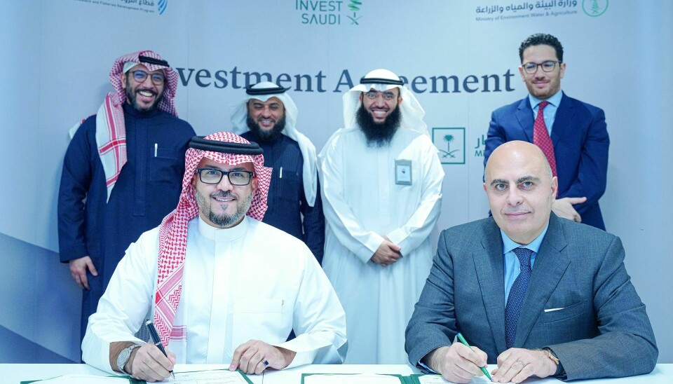 Pure Salmon chairman Stephane Farouze, right, signs an investment agreement with Saudi ministry officials.