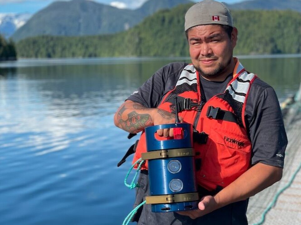 A worker holding an Innovasea stereoscopic biomass camera for Atlantic salmon that has shown good results in field trials in Canada.