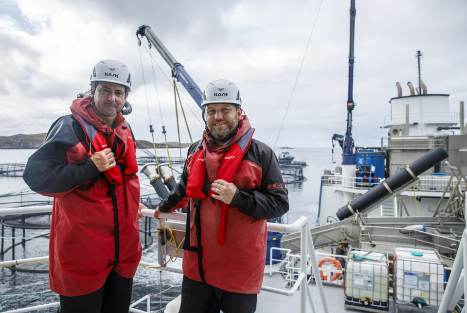 Torcuil Crichton and Ian Murray on boatd the Ronjafisk wellboat, which was operatoing at the site during their visit.