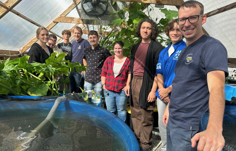 Kingfish Maine staff, students, and teacher Robin Monini (fourth from right) at an aquaponics facility used in the school aquaculture program.