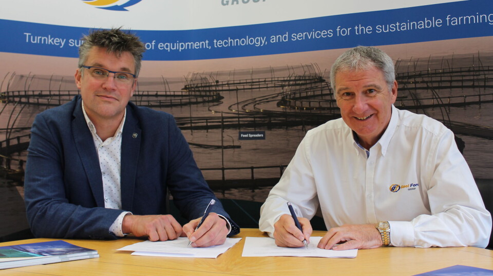 Nauplius Workboats owner Gerrit Knol, left, and Gael Force chief Stewart Graham sign an agreement that will see Nauplius make the hulls of Gael Force's range of steel feed barges.