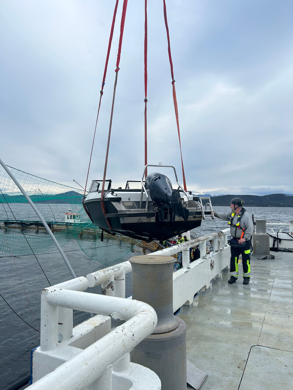 The motorboat is hoised on to a service vessel.