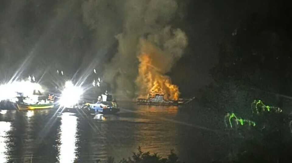 Smoke pours from a barge in Chile after an explosion in which a man was seriously injured.
