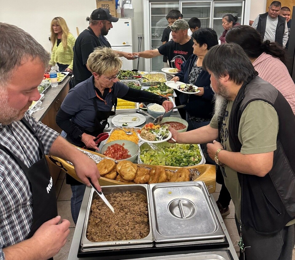 Mowi Canada West managing director Diane Morrison helps serve food after the ceremony.
