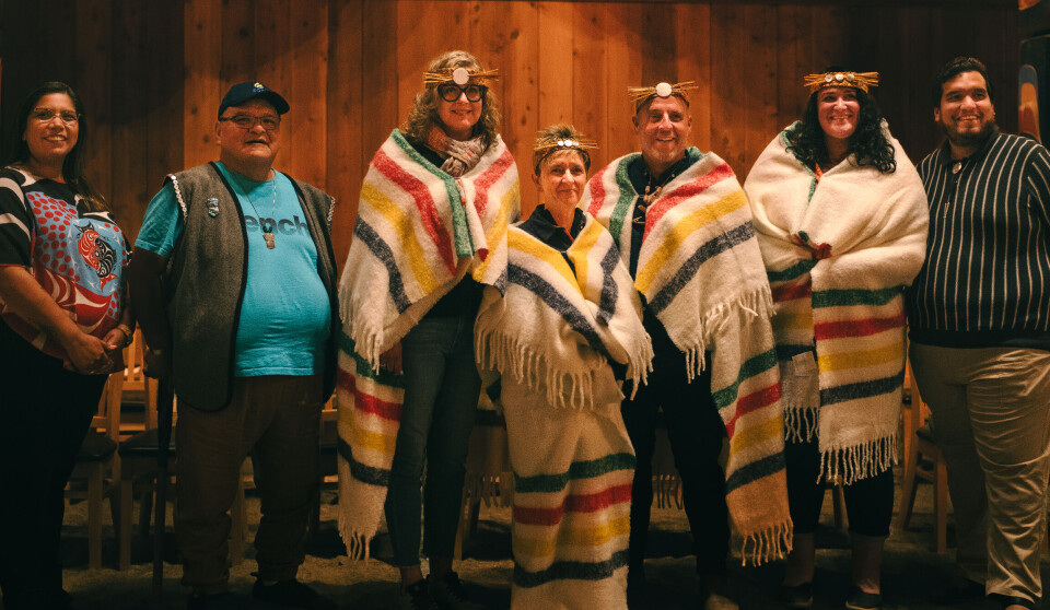 It's a wrap: From left, Roxanne Robinson; Hereditary Chief Harvey Robinson; Susan Smith from Bluesky Strategy Group; Mowi Canada West managing director Diane Morrsion; Mowi Scotland, Ireland and Canada communications director Ian Roberts; Katie Maximick, of the Coalition of First Nations for Finfish Stewardship; and Isaiah Robinson, chief executive of the Kitasoo Development Corporation, during the blanketing ceremony by the Kitasoo Xai'xais First Nation.