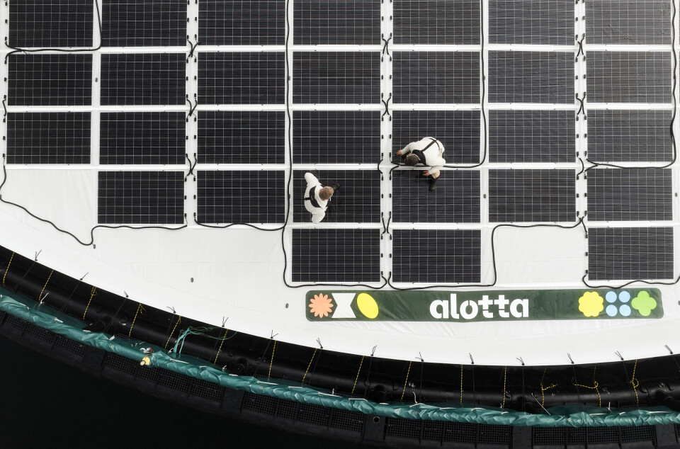 Technology with Alotta potential: flexible photo-voltaic panels being checked by engineers.