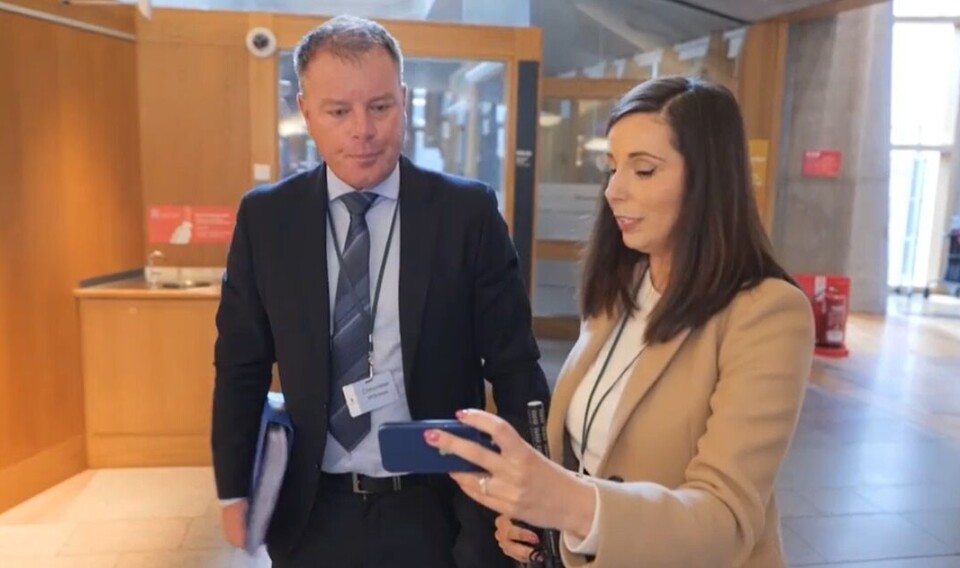 Mowi Scotland chief operating officer Ben Hadfield is shown footage of fish being buried at the Whiteshore Cockles site by ITV journalist Louise Scott.