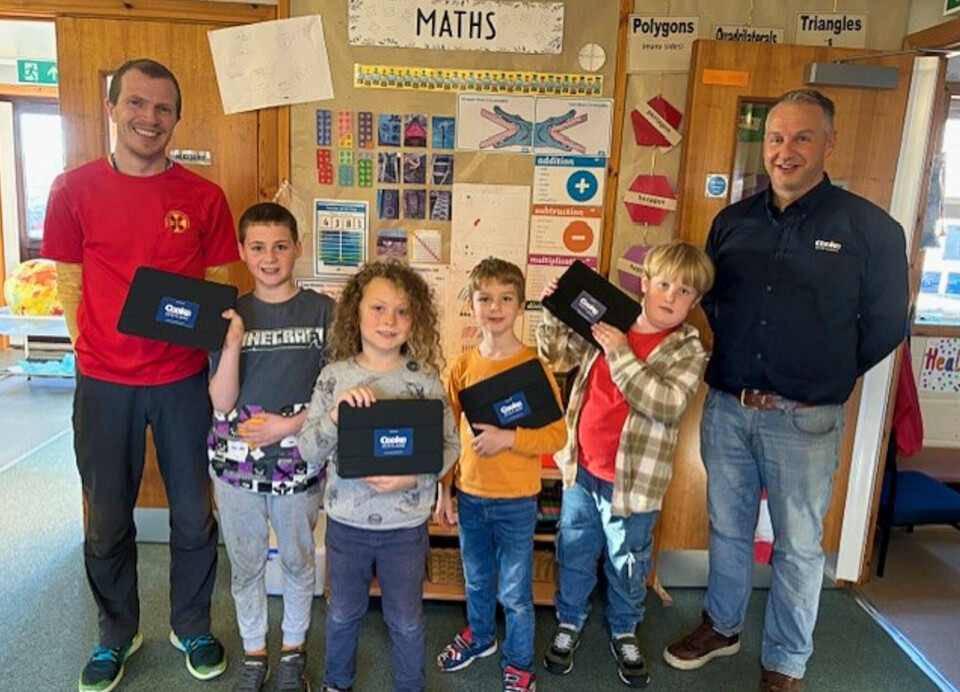 Timothy Ross, of Papa Westray Community School, left, with school pupils and Stewart Rendall, Cooke's Orkney North Isles area manager.