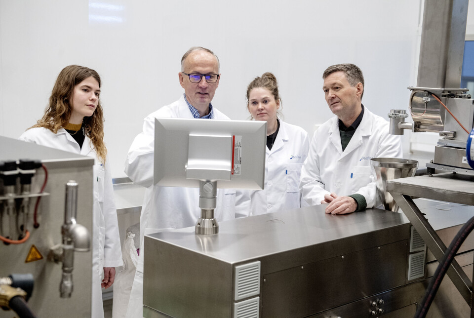 Tor Andreas Samuelsen, right, and colleagues at one of the extruders used in feed research.