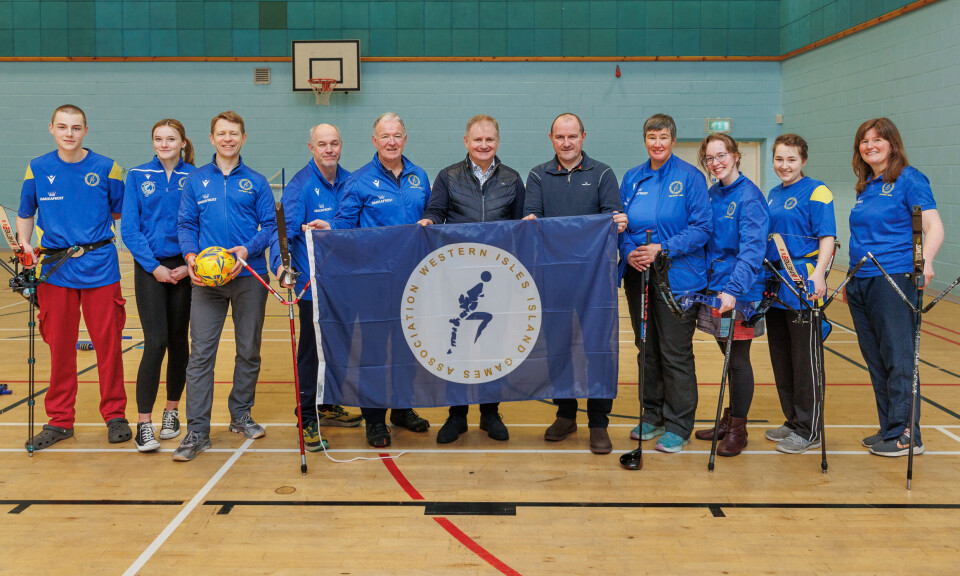 Islanders hoping to compete in the International Island Games. Holding the flag are, from left: Iain GG Campbell (WIIGA), Norman MacDonald (Comhairle nan Eilean Siar / Western Isles Council) and Ian Laister (Bakkafrost).