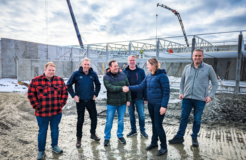 Mathias Bjørge co-owner Henning Bjørge and Maritech's Astrid Bolstad Dale seal the deal with a handshake at the site of the new factory outside Ålesund, Norway. From left: Ole Martin Strømsnes, technical manager for Mathias Bjørge; chief executive Torgeir Bjørge; Henning Bjørge; Maritech sales manager Johan Petter Loe; Astrid Bolstad Dale; Andre Lillebakk.