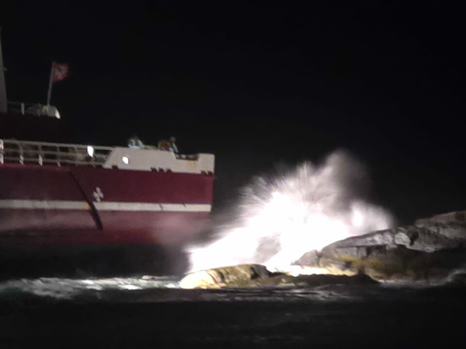 Waves hit the stern of the Rotsun and the rocks.