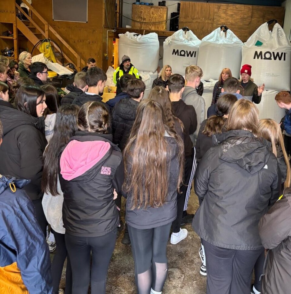 The Plockton pupils being briefed at a shore base. Their four-day experience included learning about feed, seen in the background.