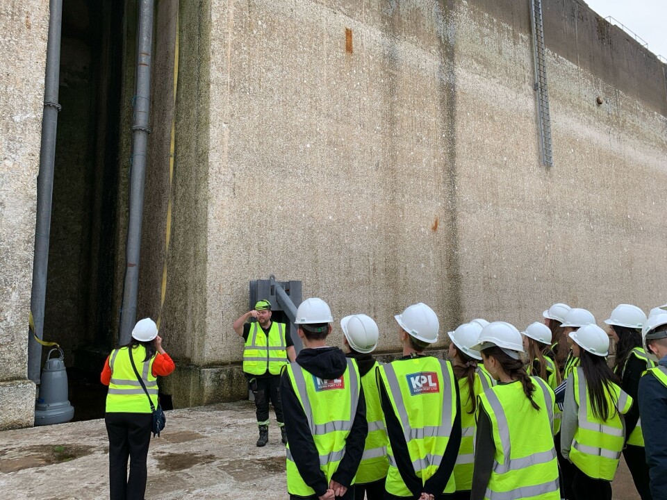 The pupils take a look at the huge concrete gates that keep the water out of the dry dock at Kishorn Port.