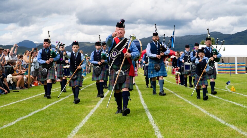 The Isle of Skye Pipe Band march down the track.