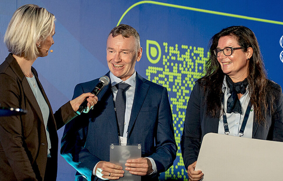GreenFox Marine chief executive Erling Aspen, centre, and sales chief Kjersti Jullum, right, collect the Innovation Award at Aqua Nor. It is presented by the trade show's organiser, the Nor-Fishing Foundation.