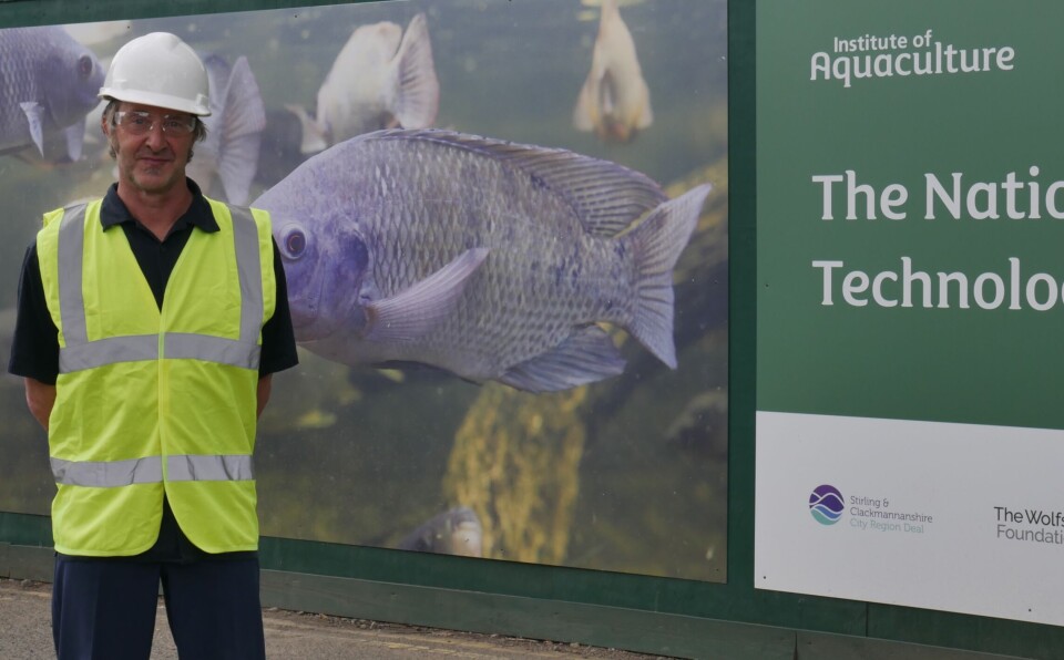 Former IoA chief Simon MacKenzie pictured last month in front of a hoarding advertising the National Aquaculture Technology and Innovation Centre (NATIH) on the Stirling University campus.