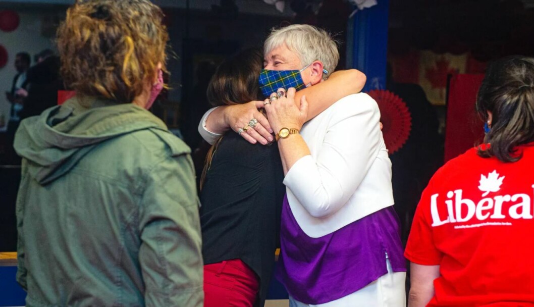 Bernadette Jordan (with tartan mask) hugs a supporter after losing her seat. Bernadette Jordan (with tartan mask) hugs a supporter after losing her seat.